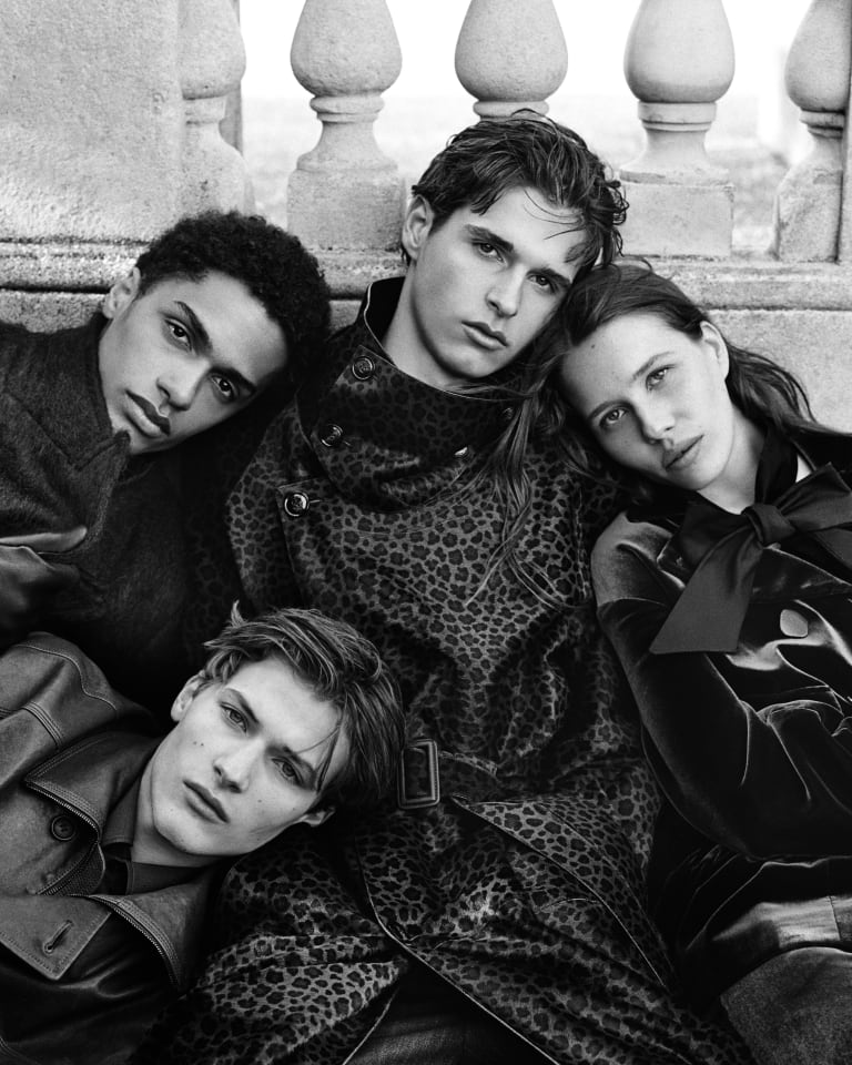 Video showing different models wearing apparel from the Emporio Armani Autumn/Winter 2024 collection moving in a dreamlike situation with an illuminated lighthouse in the middle of the scene positioned in the sky between clouds and raindrops