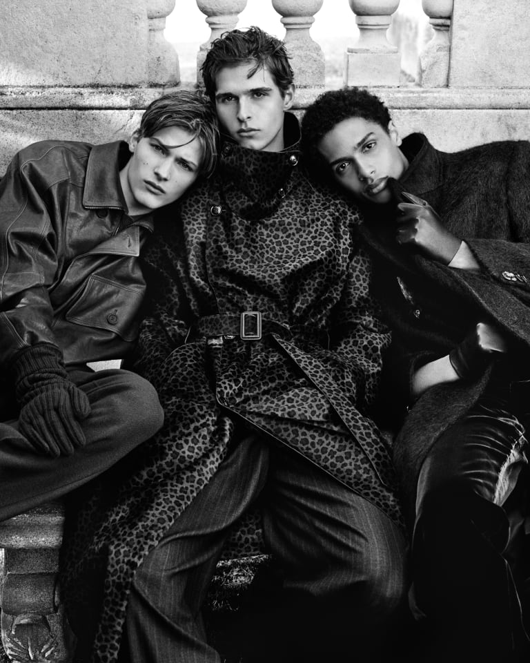 Video showing different models wearing apparel from the Emporio Armani Autumn/Winter 2024 collection moving in a dreamlike situation with an illuminated lighthouse in the middle of the scene positioned in the sky between clouds and raindrops