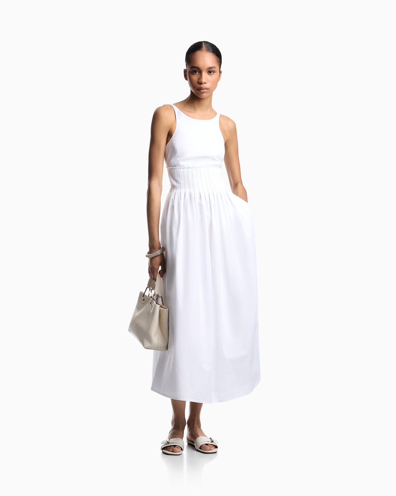 Long dress in poplin with smocked motif Slide 1