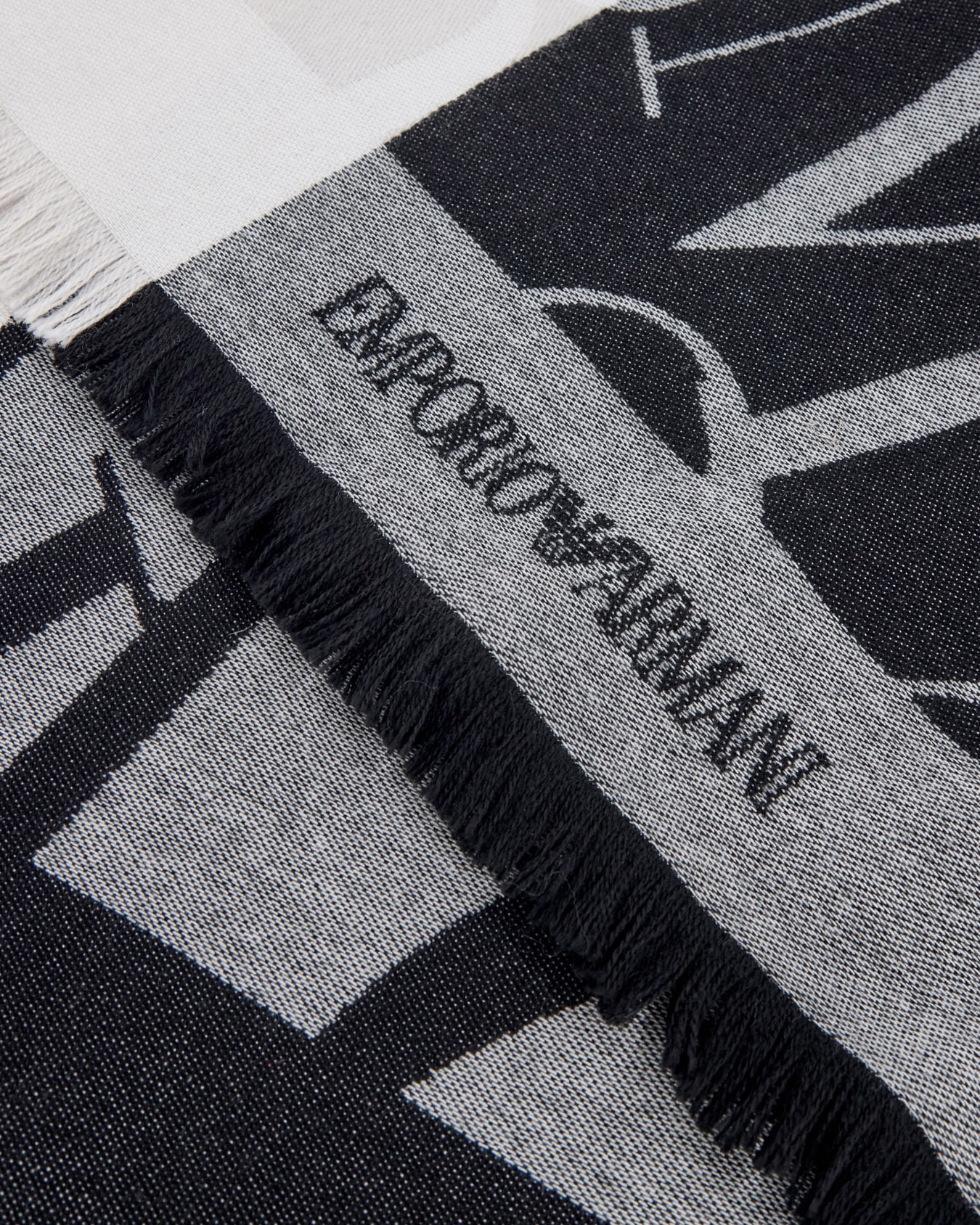 Jacquard logo stole in wool and cashmere with fringed edges Slide 1