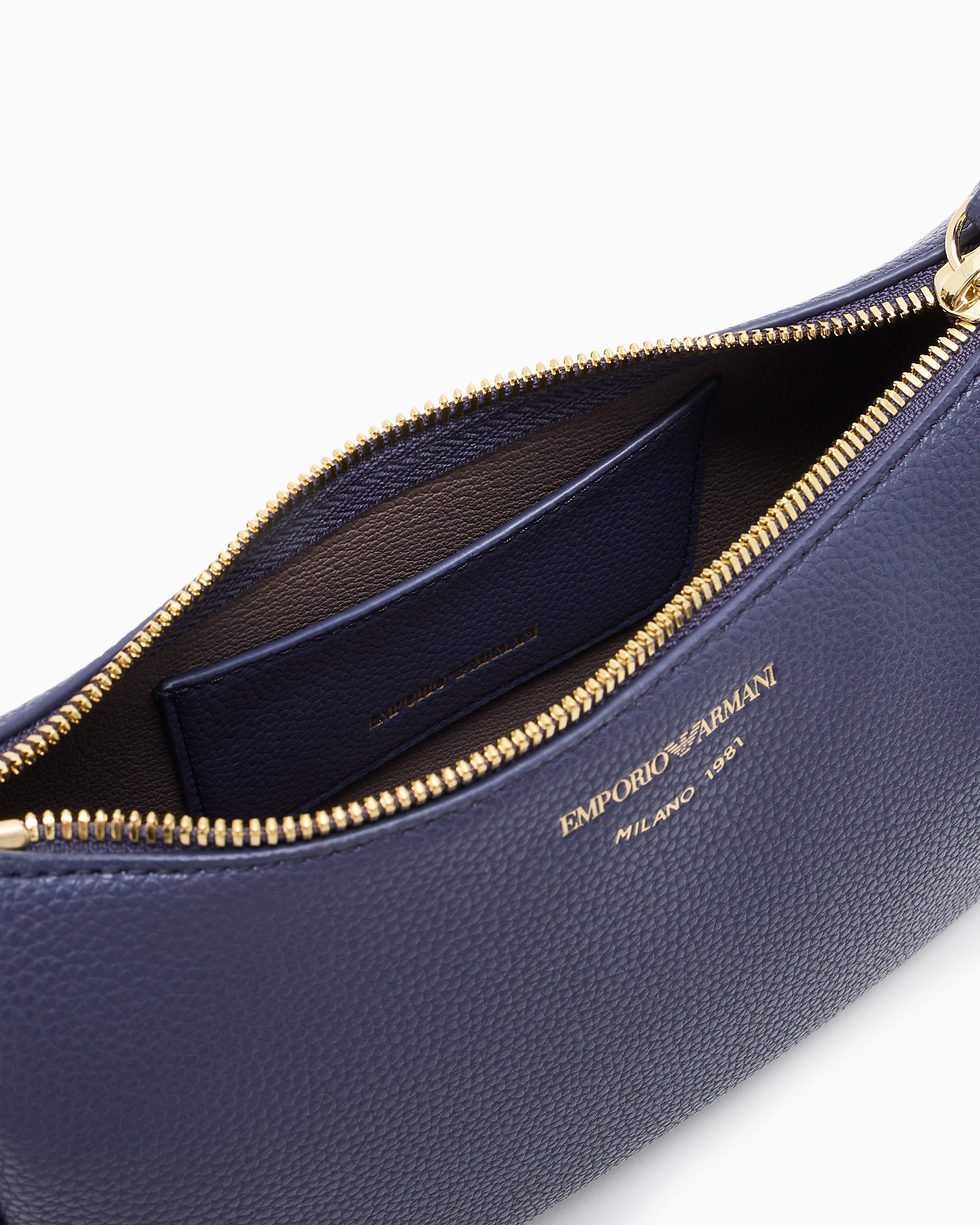 Pebbled shoulder bag with a zip closure and adjustable strap