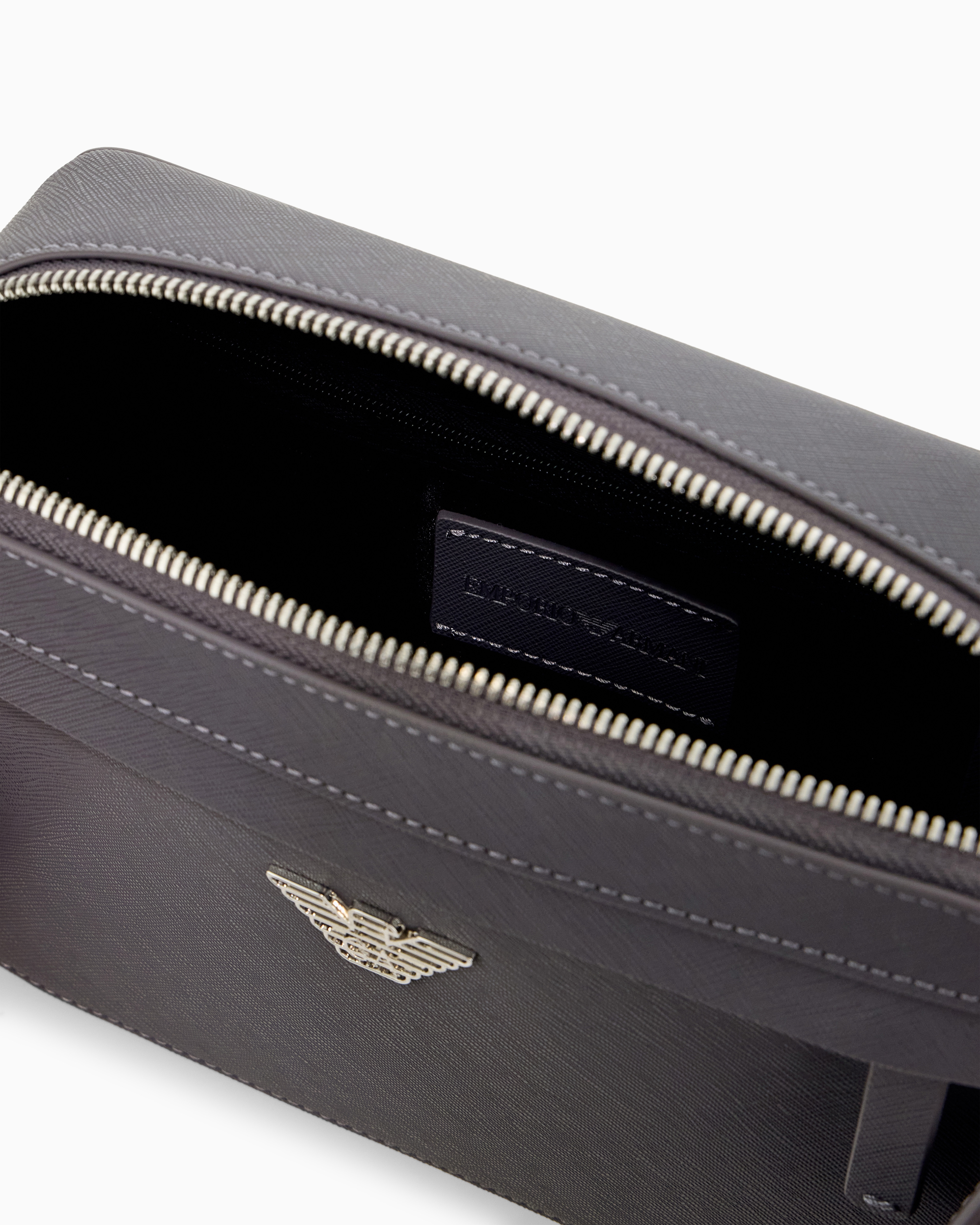 Textured crossbody bag with a front pocket and a metal logo