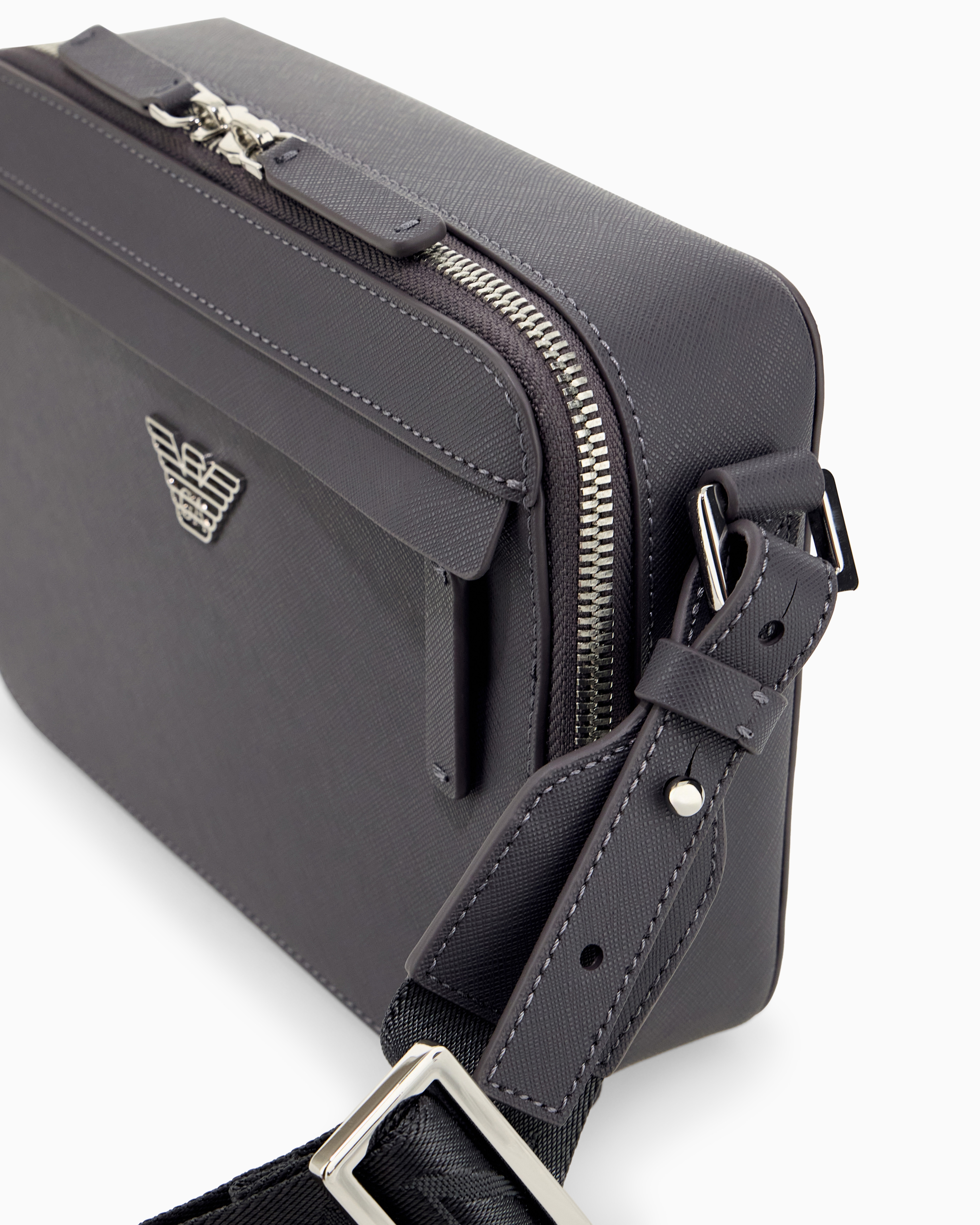 Textured crossbody bag with a front pocket and a metal logo